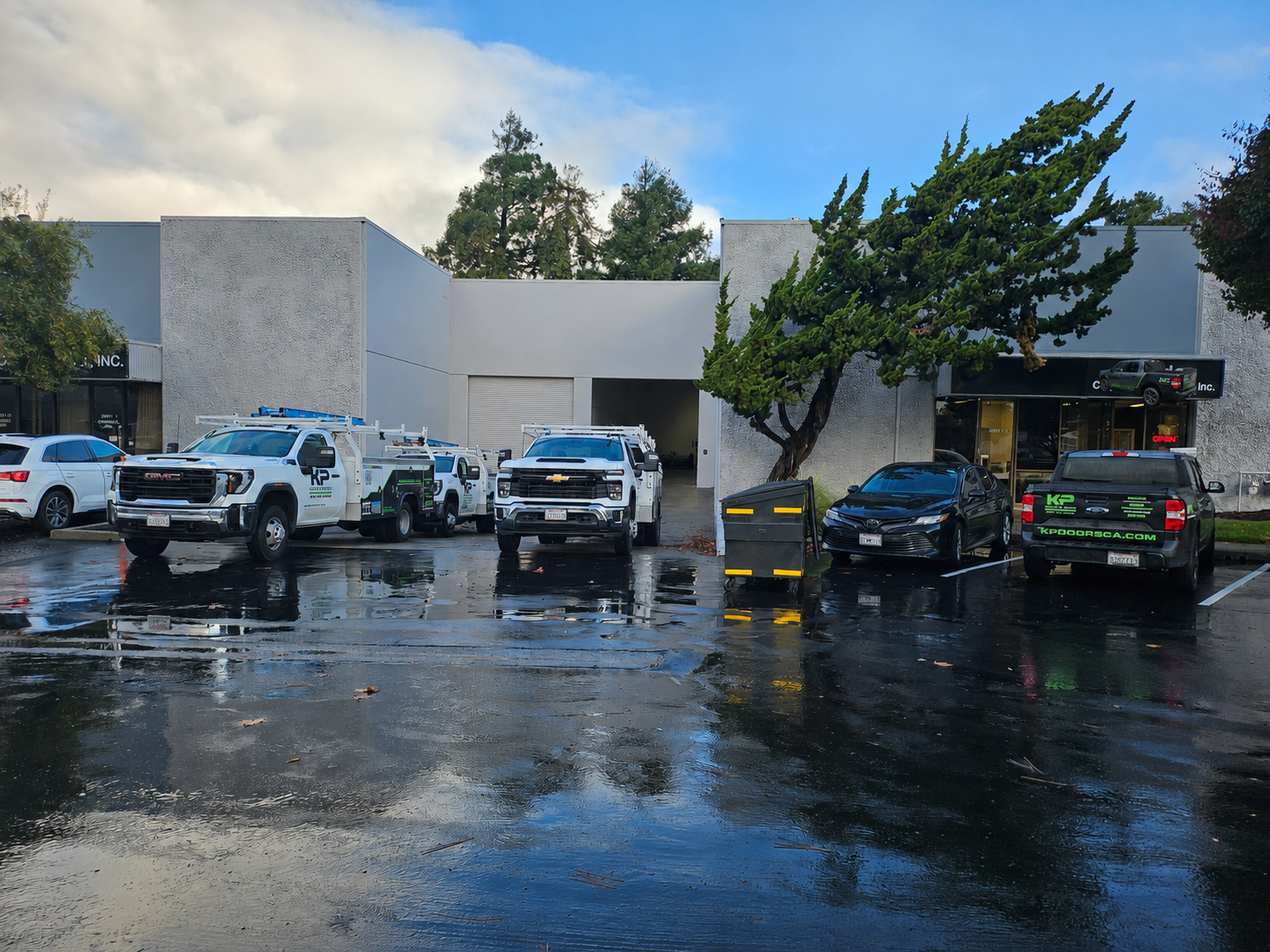 KP Doors trucks parked outside of office building